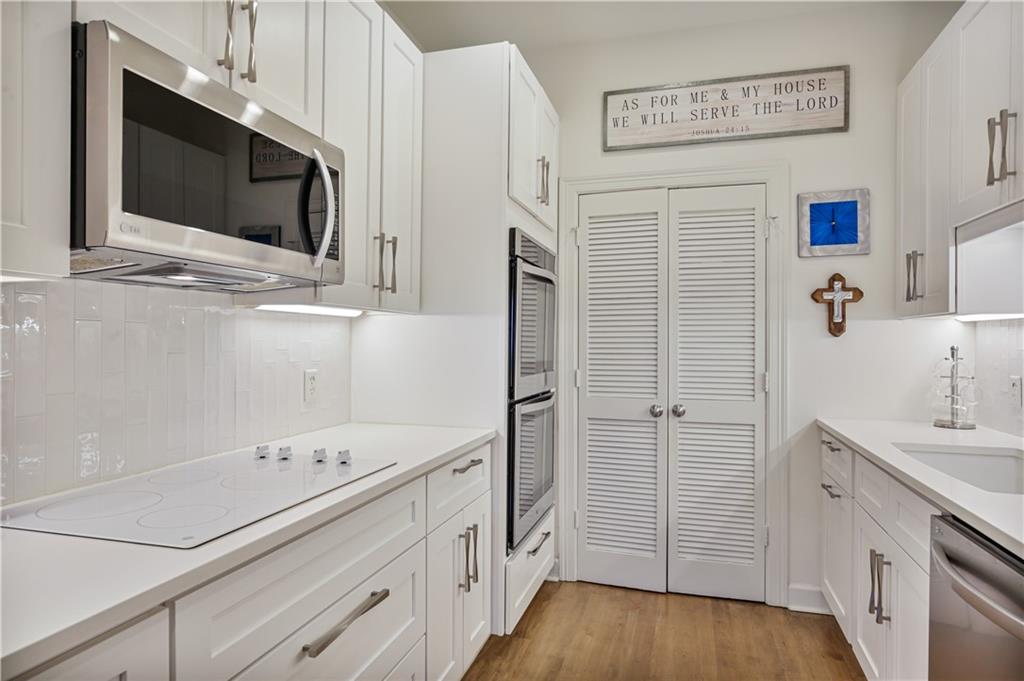3445 Stratford Road Northeast, Unit 3703 Atlanta, GA 30326 - Photo 14 of 59 a kitchen with stainless steel appliances white cabinets and wooden floor