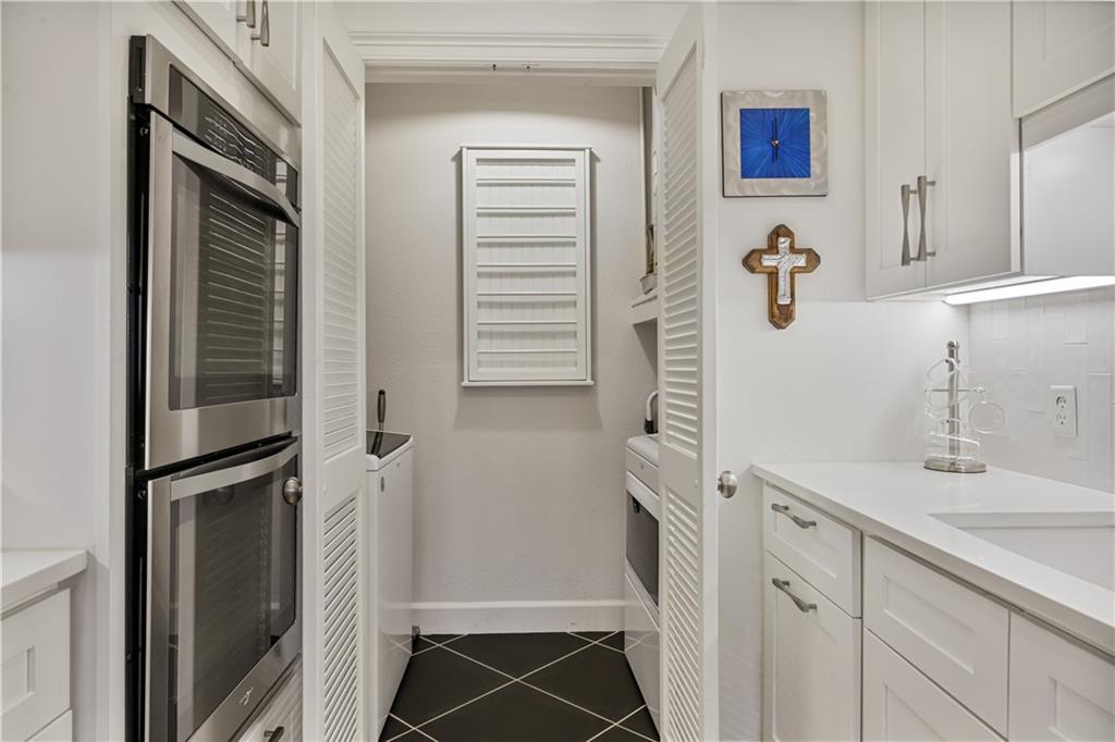 3445 Stratford Road Northeast, Unit 3703 Atlanta, GA 30326 - Photo 16 of 59 a bathroom with a sink and mirror