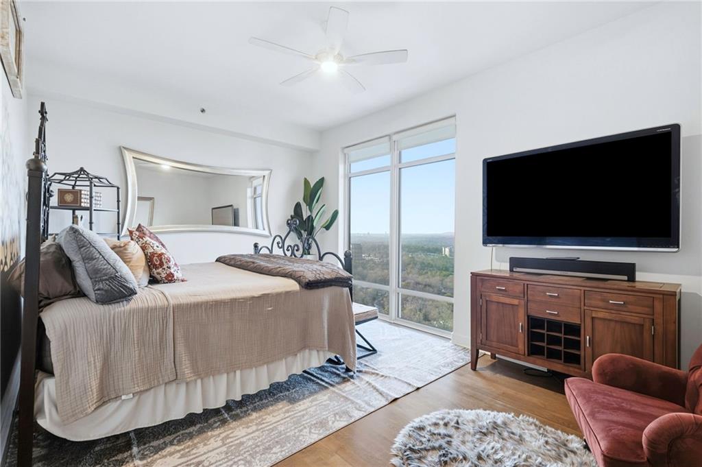 3445 Stratford Road Northeast, Unit 3703 Atlanta, GA 30326 - Photo 18 of 59 a bedroom with a bed and a flat screen television