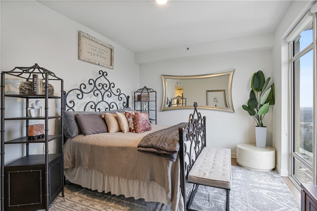 3445 Stratford Road Northeast, Unit 3703 Atlanta, GA 30326 - Photo 20 of 59 a bedroom with furniture and a potted plant