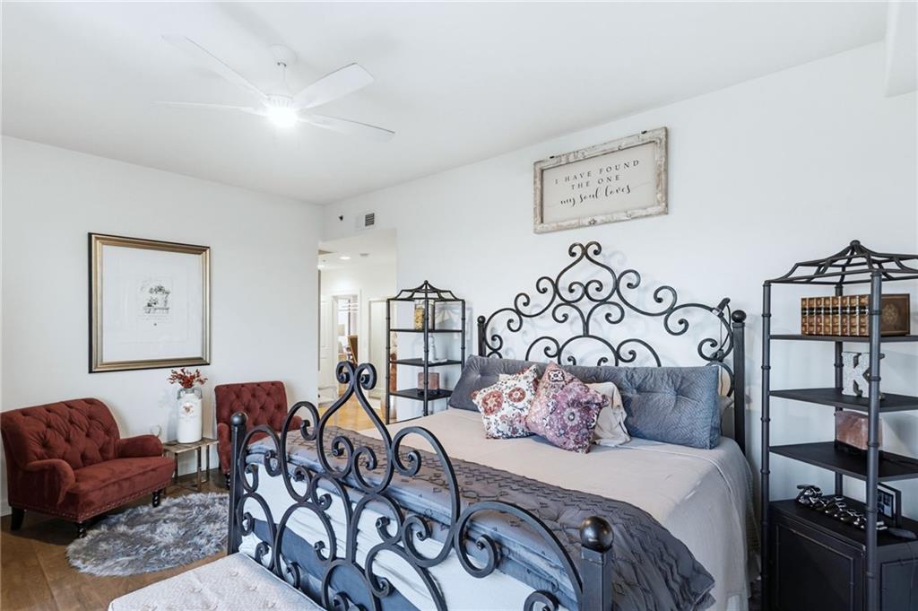 3445 Stratford Road Northeast, Unit 3703 Atlanta, GA 30326 - Photo 22 of 59 a bedroom with furniture and wooden floor