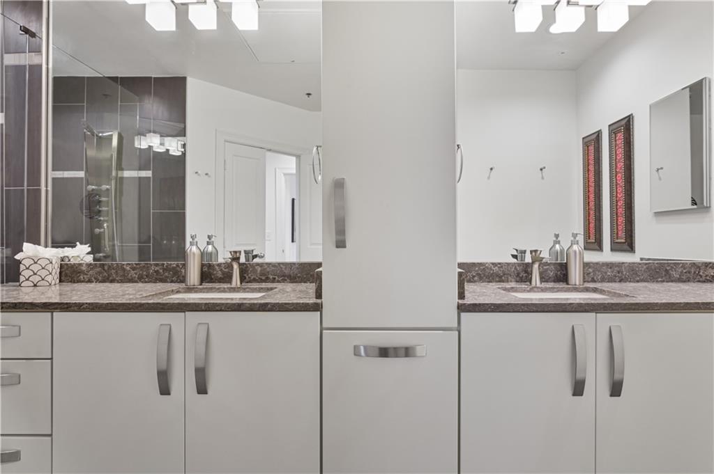 3445 Stratford Road Northeast, Unit 3703 Atlanta, GA 30326 - Photo 26 of 59 a bathroom with a granite countertop sink and a mirror