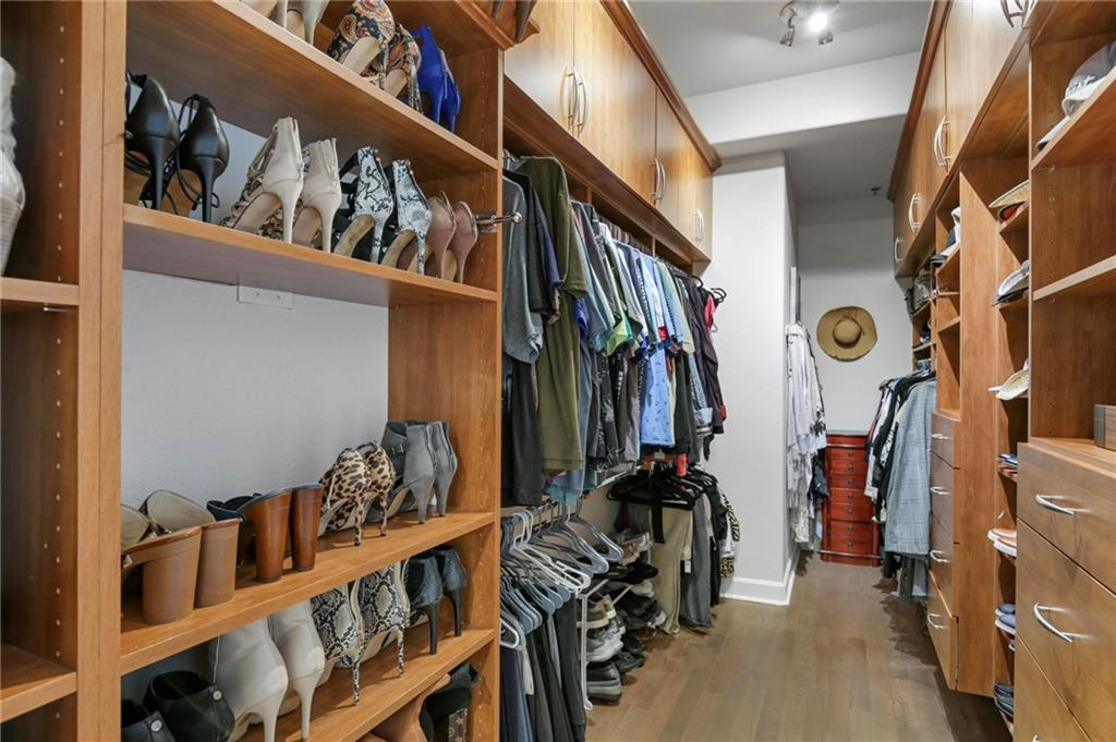 3445 Stratford Road Northeast, Unit 3703 Atlanta, GA 30326 - Photo 28 of 59 a view of walk in closet with clothes and shoes