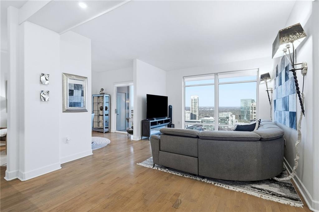 3445 Stratford Road Northeast, Unit 3703 Atlanta, GA 30326 - Photo 3 of 59 a living room with furniture and a flat screen tv