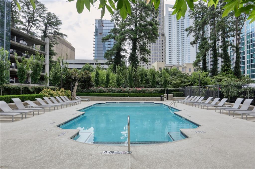 3445 Stratford Road Northeast, Unit 3703 Atlanta, GA 30326 - Photo 38 of 59 a view of a swimming pool with a lounge chair