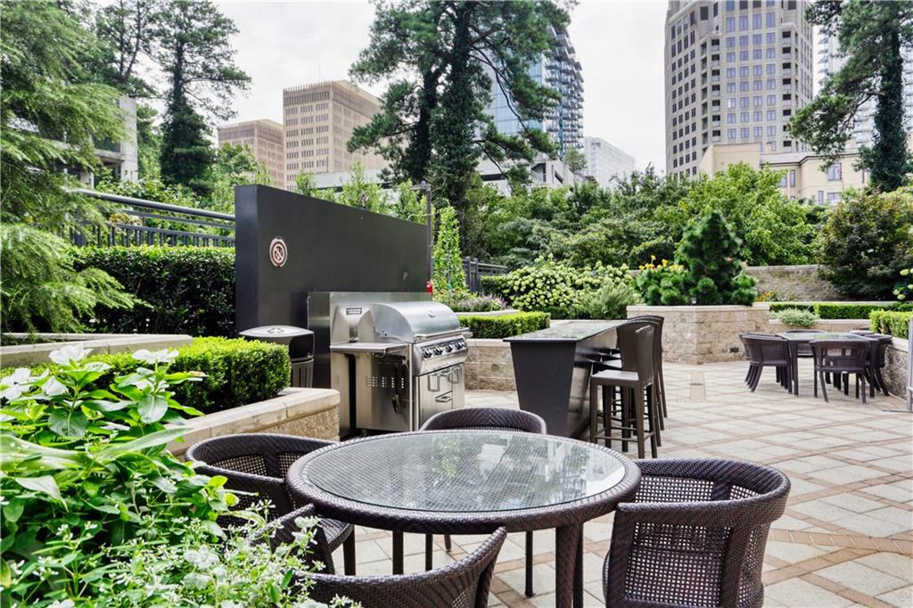 3445 Stratford Road Northeast, Unit 3703 Atlanta, GA 30326 - Photo 43 of 59 a backyard of a house with yard and outdoor seating