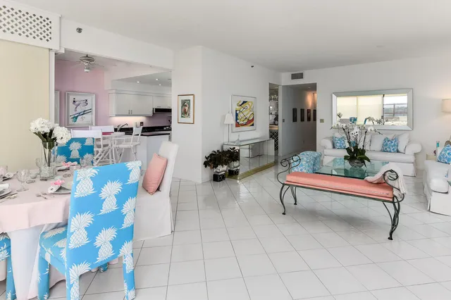 a living room with furniture a rug and white walls