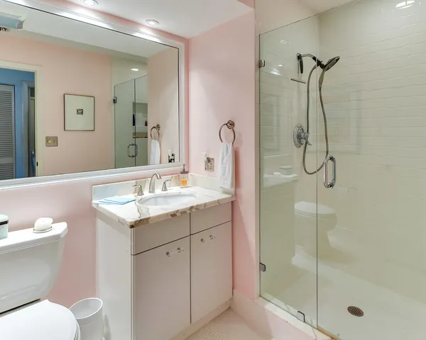 a bathroom with a granite countertop sink toilet and shower
