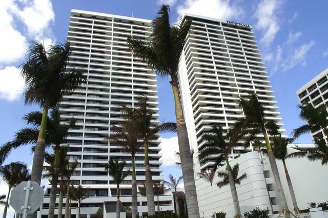 a front view of a building with palm tree