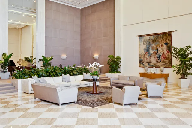 a living room with furniture and flowers