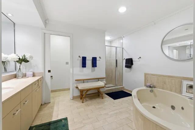 a bathroom with a bathtub sink and mirror