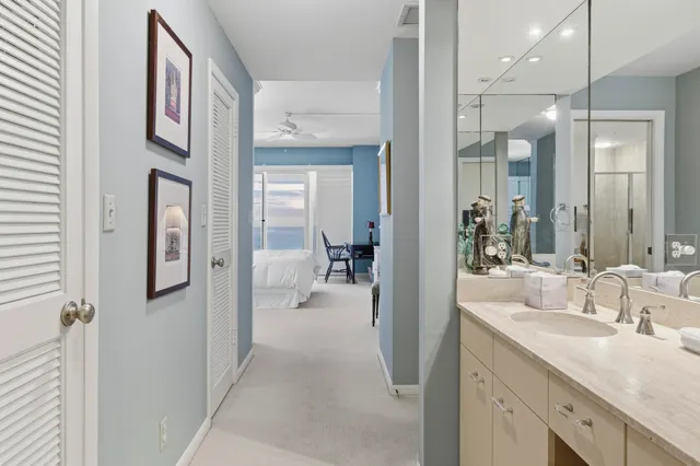 a en suite bathroom with a sink a mirror a vanity and shower