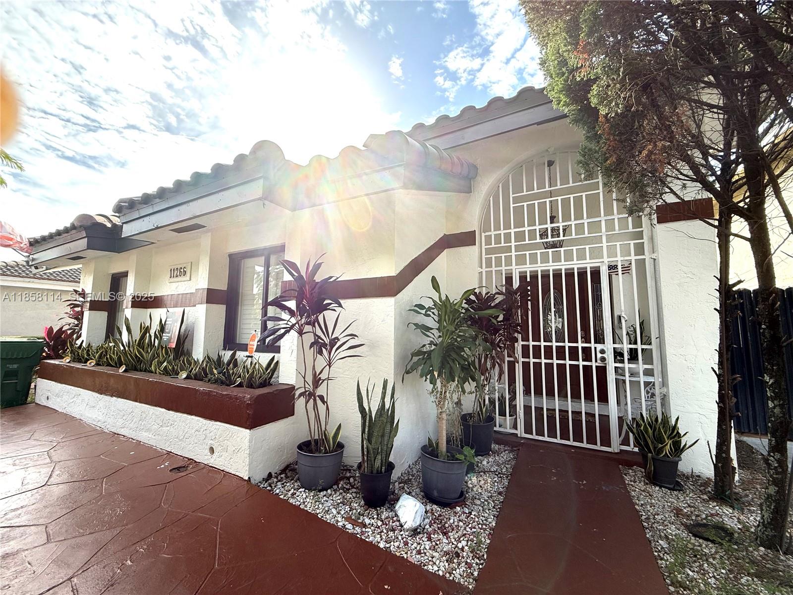 a view of a house with backyard and sitting area