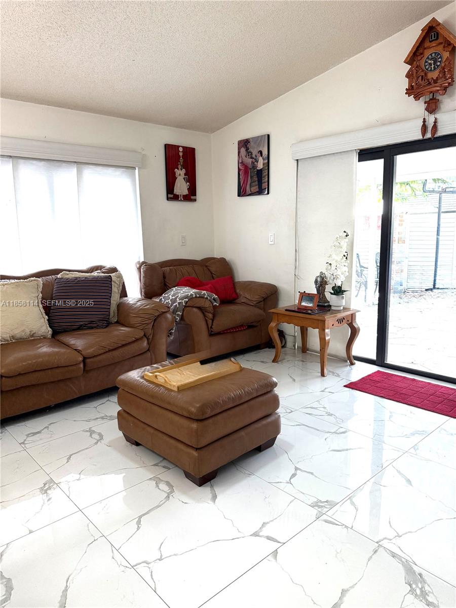 11266 Southwest 33rd Street Miami, FL 33165 - Photo 14 of 19 a living room with furniture and a large window