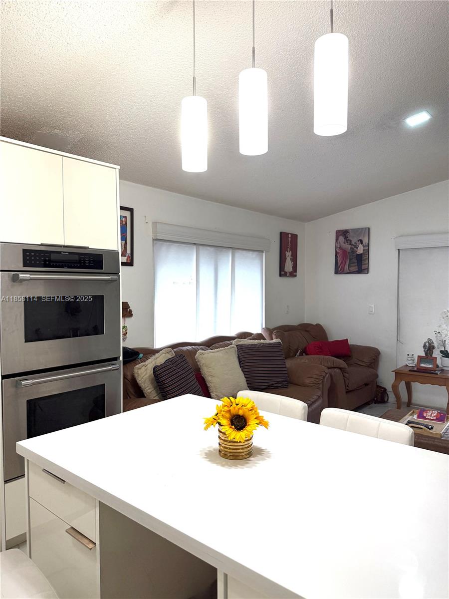 11266 Southwest 33rd Street Miami, FL 33165 - Photo 15 of 19 a living room with a couch and a fireplace