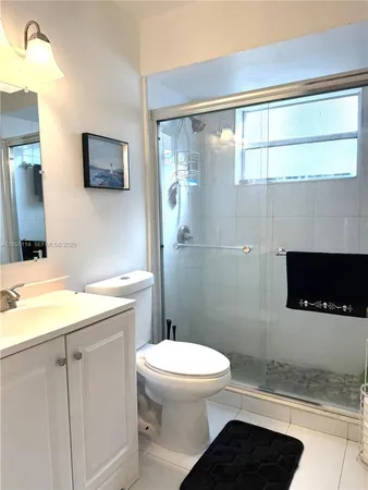 a bathroom with a toilet a sink and a mirror