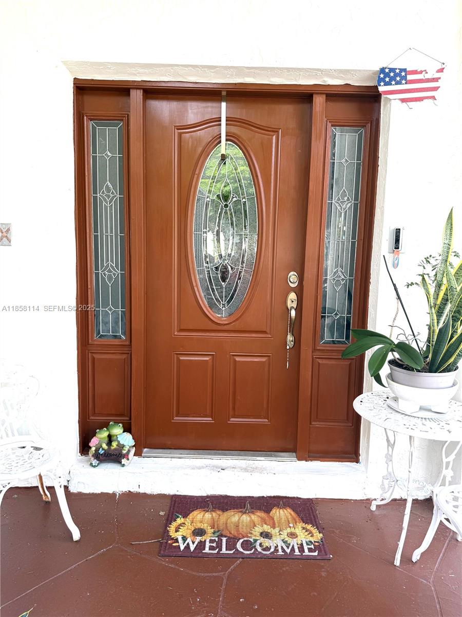 11266 Southwest 33rd Street Miami, FL 33165 - Photo 3 of 19 a front view of a house with garden