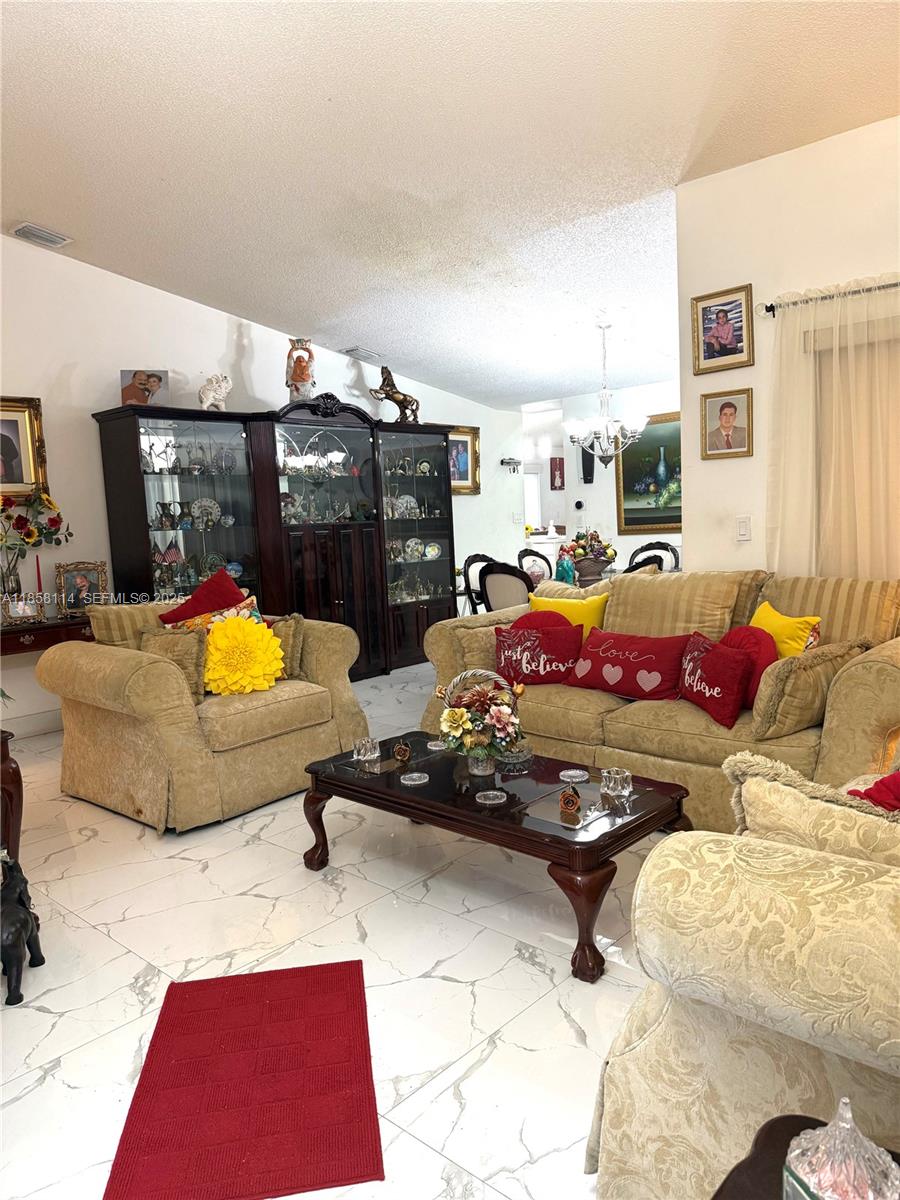 11266 Southwest 33rd Street Miami, FL 33165 - Photo 4 of 19 a bedroom with furniture and a couch