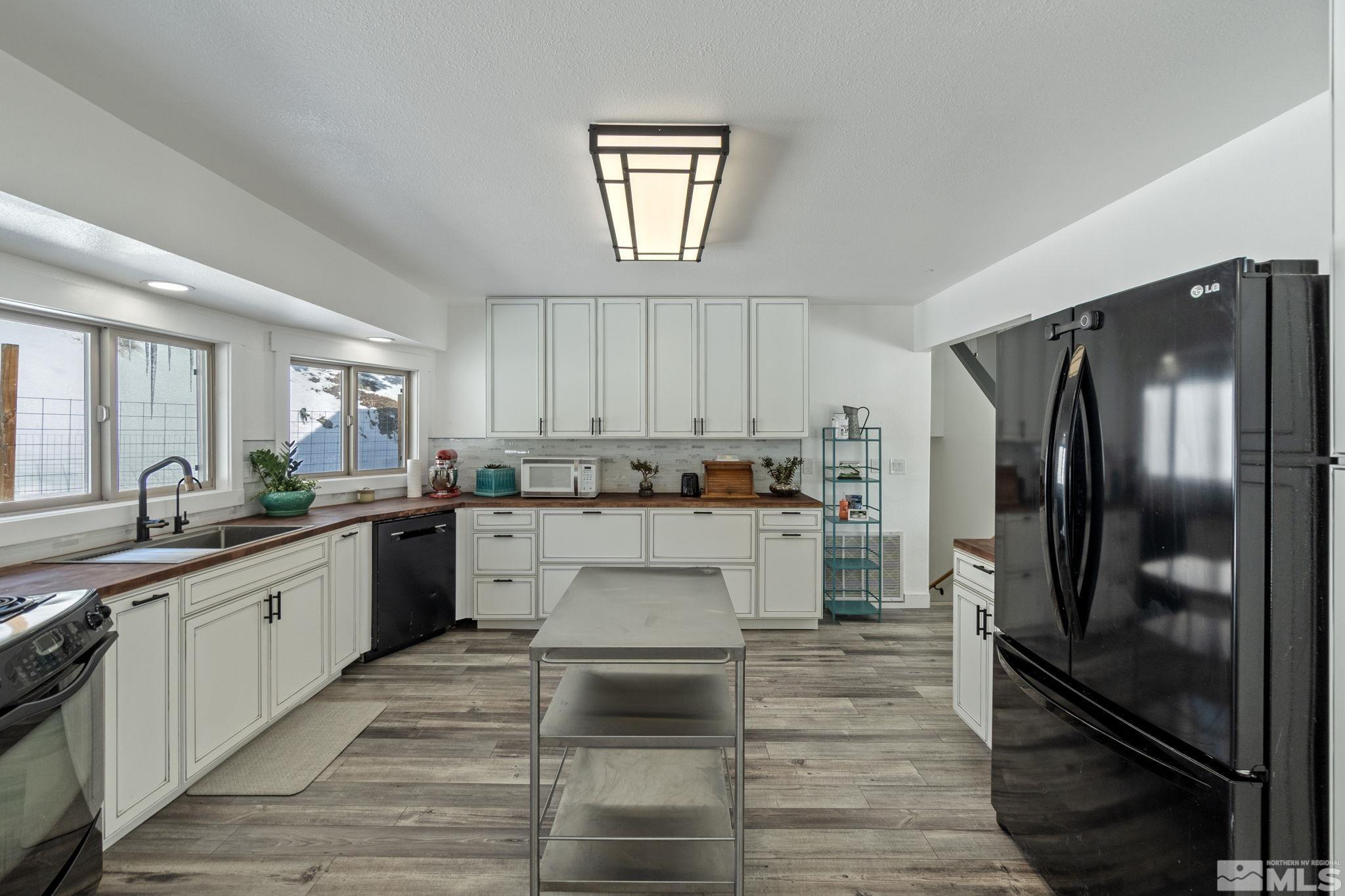 2440 Adobe Reno, NV 89521 - Photo 20 of 40 a large kitchen with cabinets stainless steel appliances and a window