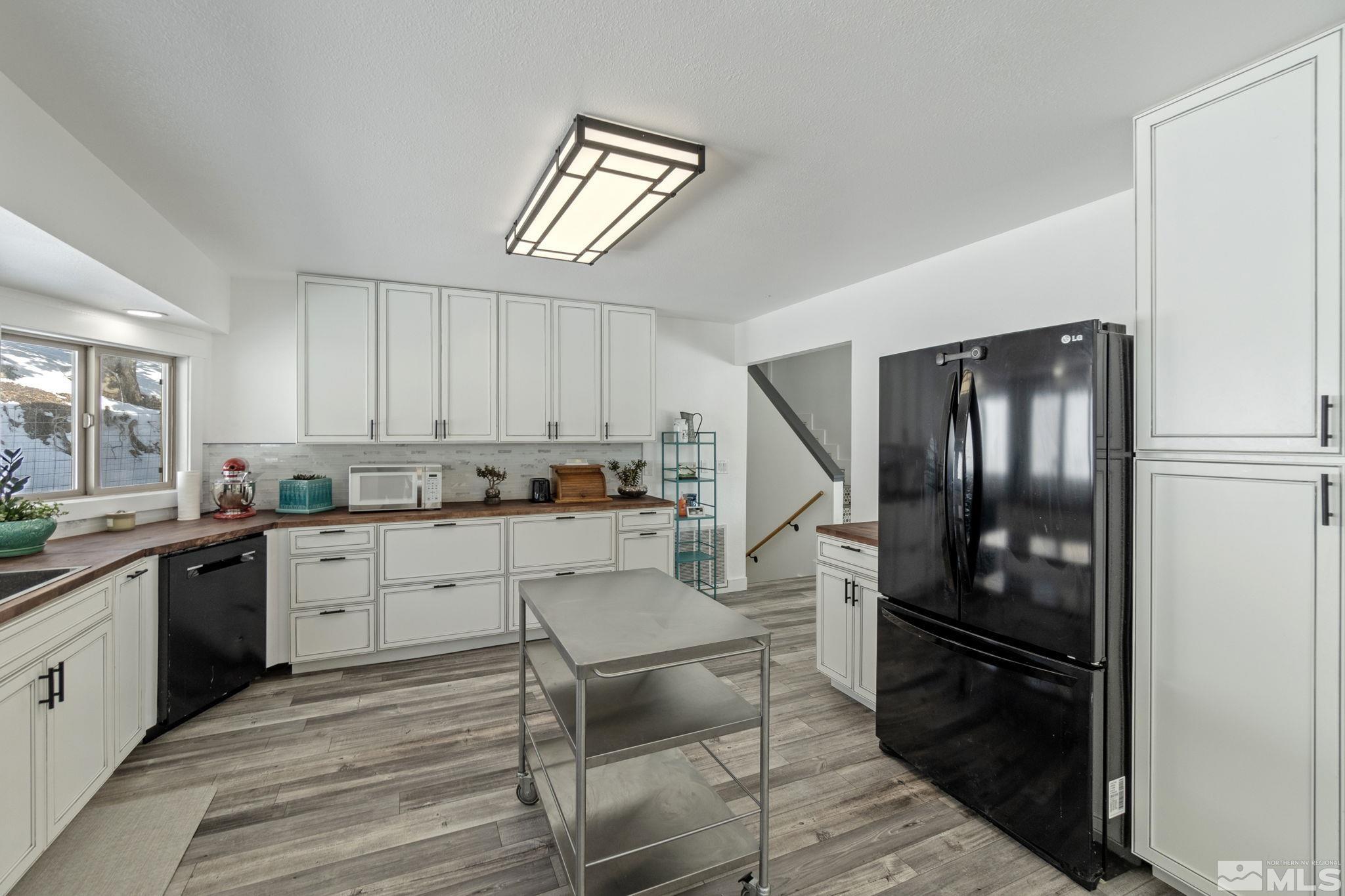 2440 Adobe Reno, NV 89521 - Photo 21 of 40 a kitchen with a refrigerator and white cabinets