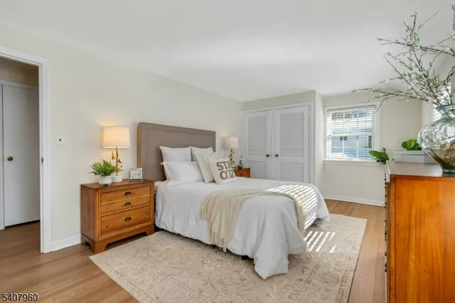 a bedroom with a bed and a night stand