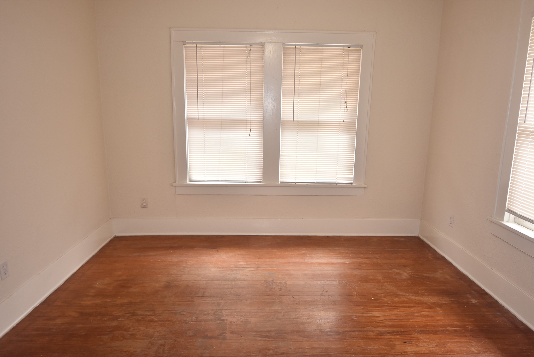 4618 Clay Street, Unit 2 Houston, TX 77023 - Photo 17 of 38 an empty room with wooden floor and windows