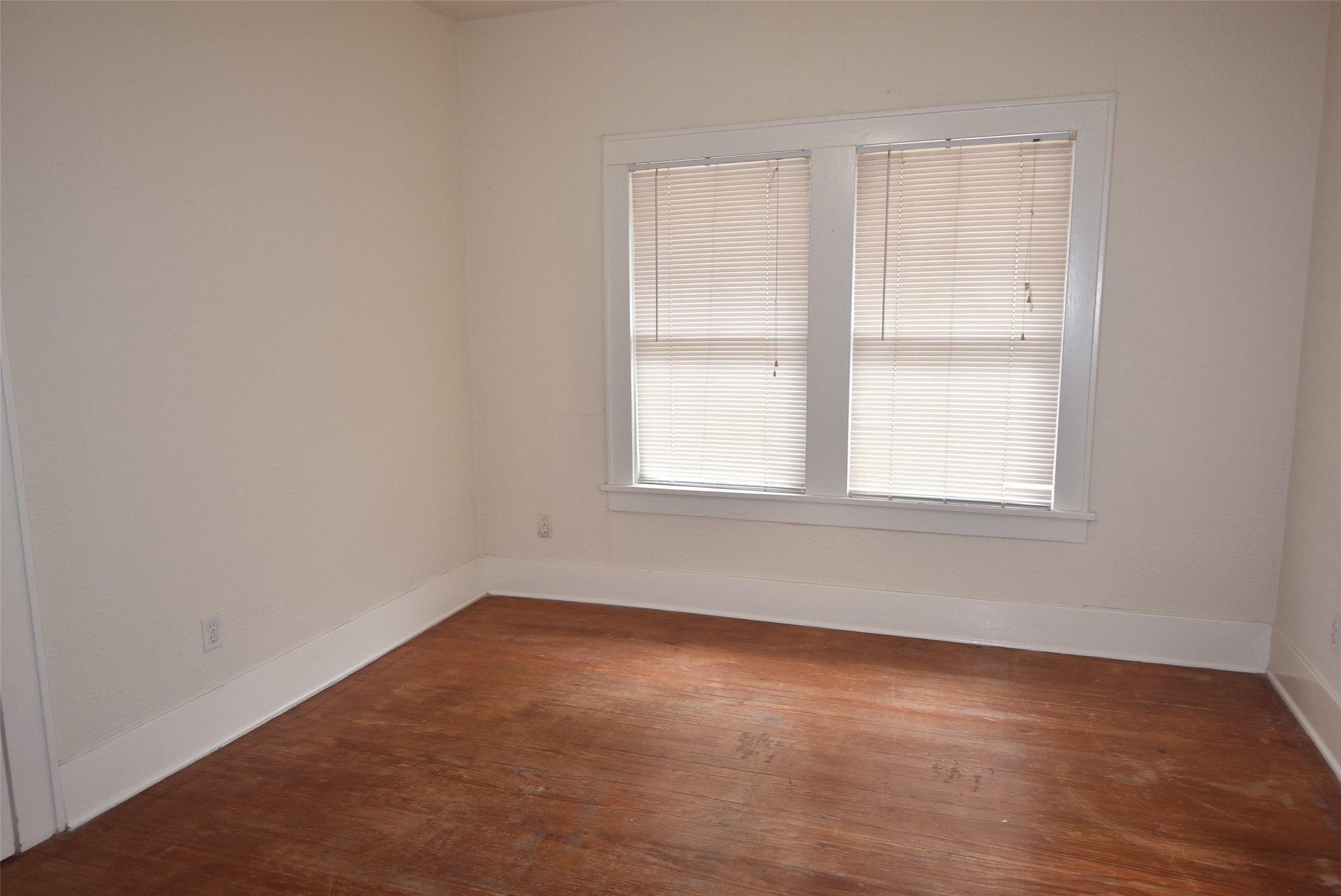 4618 Clay Street, Unit 2 Houston, TX 77023 - Photo 18 of 38 an empty room with wooden floor and windows