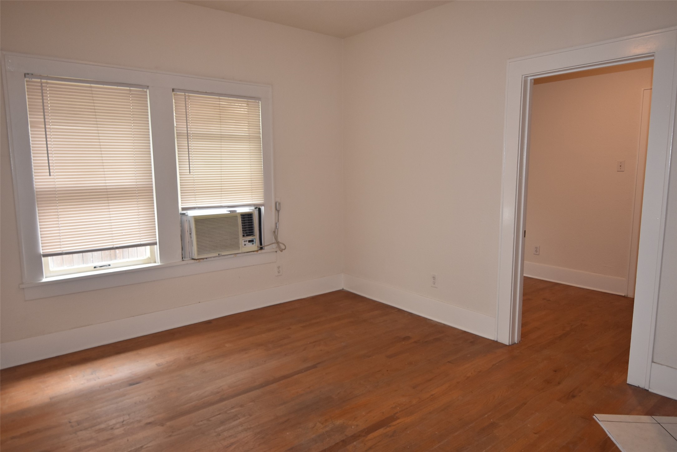 4618 Clay Street, Unit 2 Houston, TX 77023 - Photo 6 of 38 a view of an empty room with wooden floor and a window