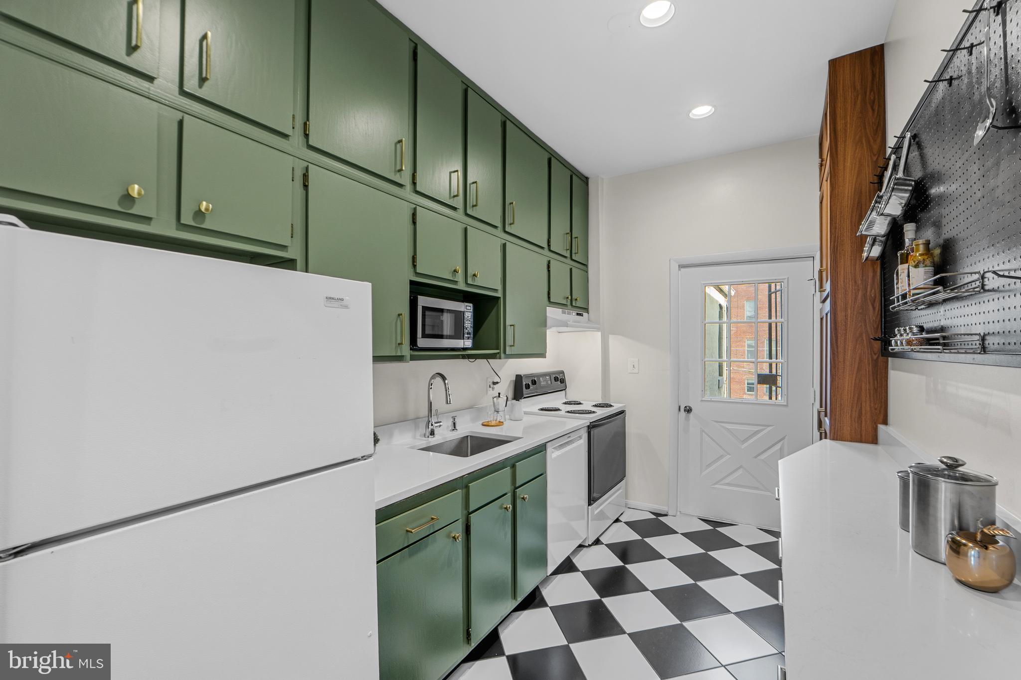 1927 15th Street Northwest Washington, DC 20009 - Photo 13 of 59 a kitchen with a sink a stove and a refrigerator