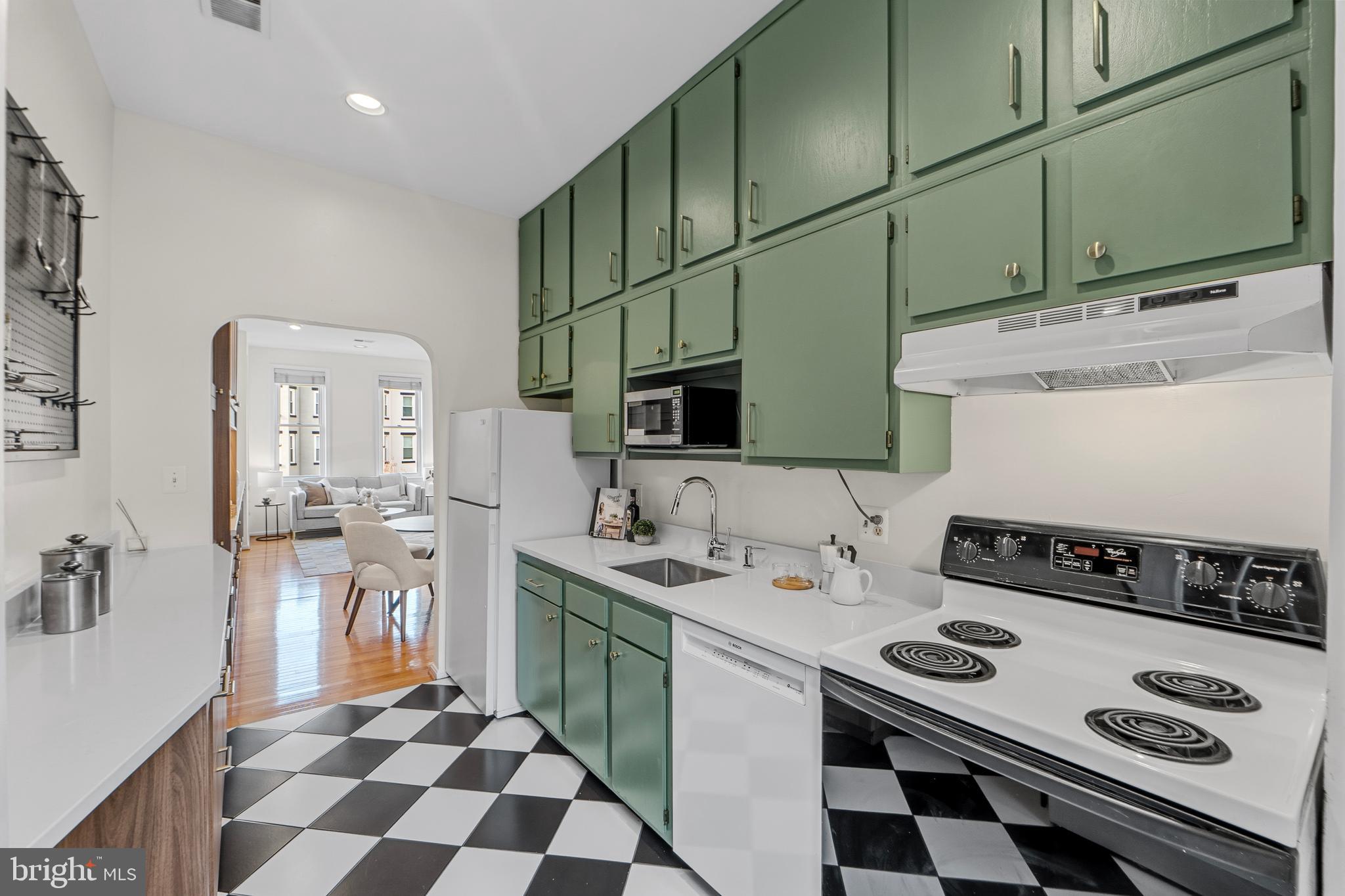 1927 15th Street Northwest Washington, DC 20009 - Photo 15 of 59 a kitchen with stainless steel appliances a sink stove and cabinets