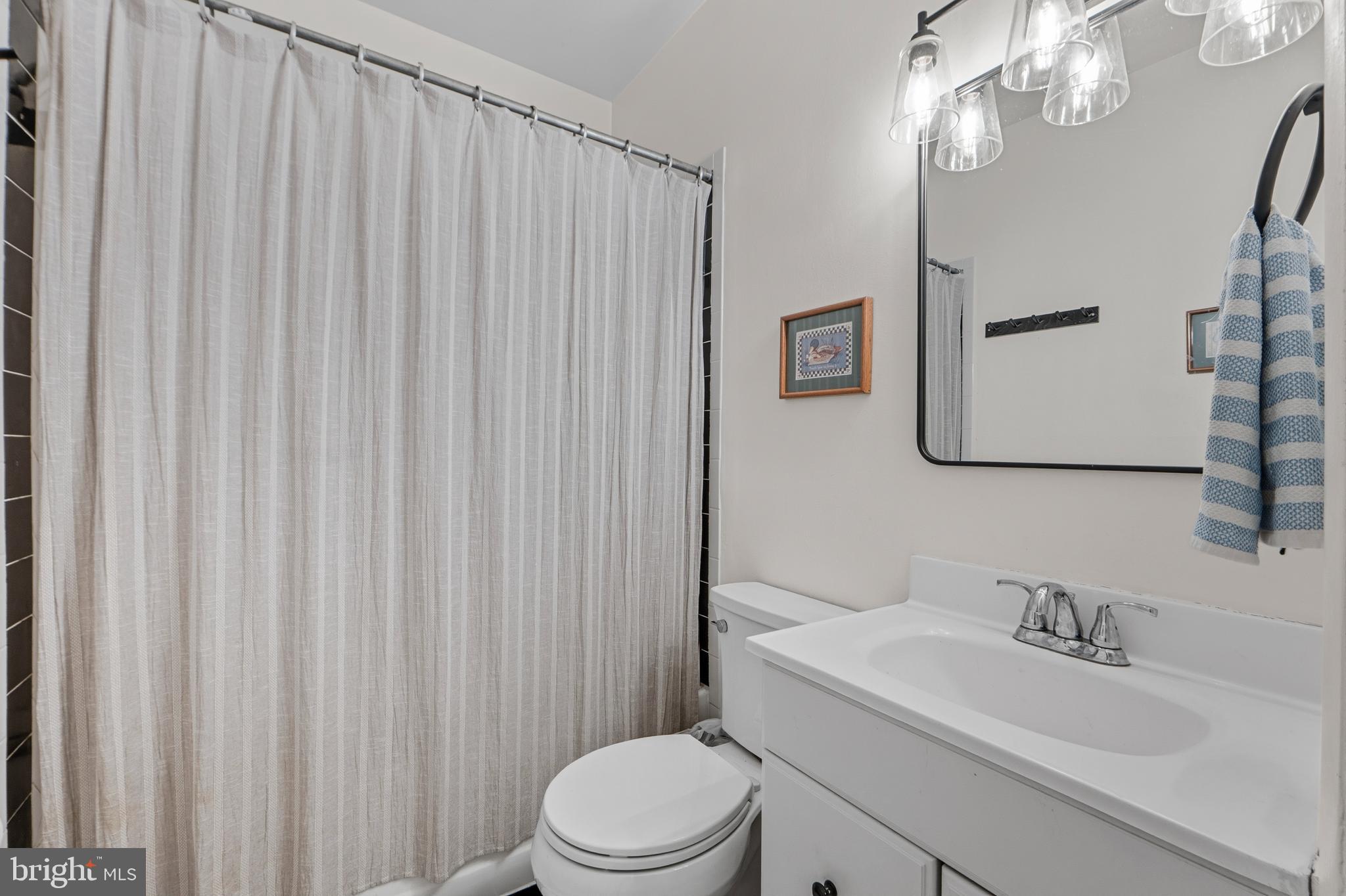 1927 15th Street Northwest Washington, DC 20009 - Photo 34 of 59 a bathroom with a toilet a sink and a mirror