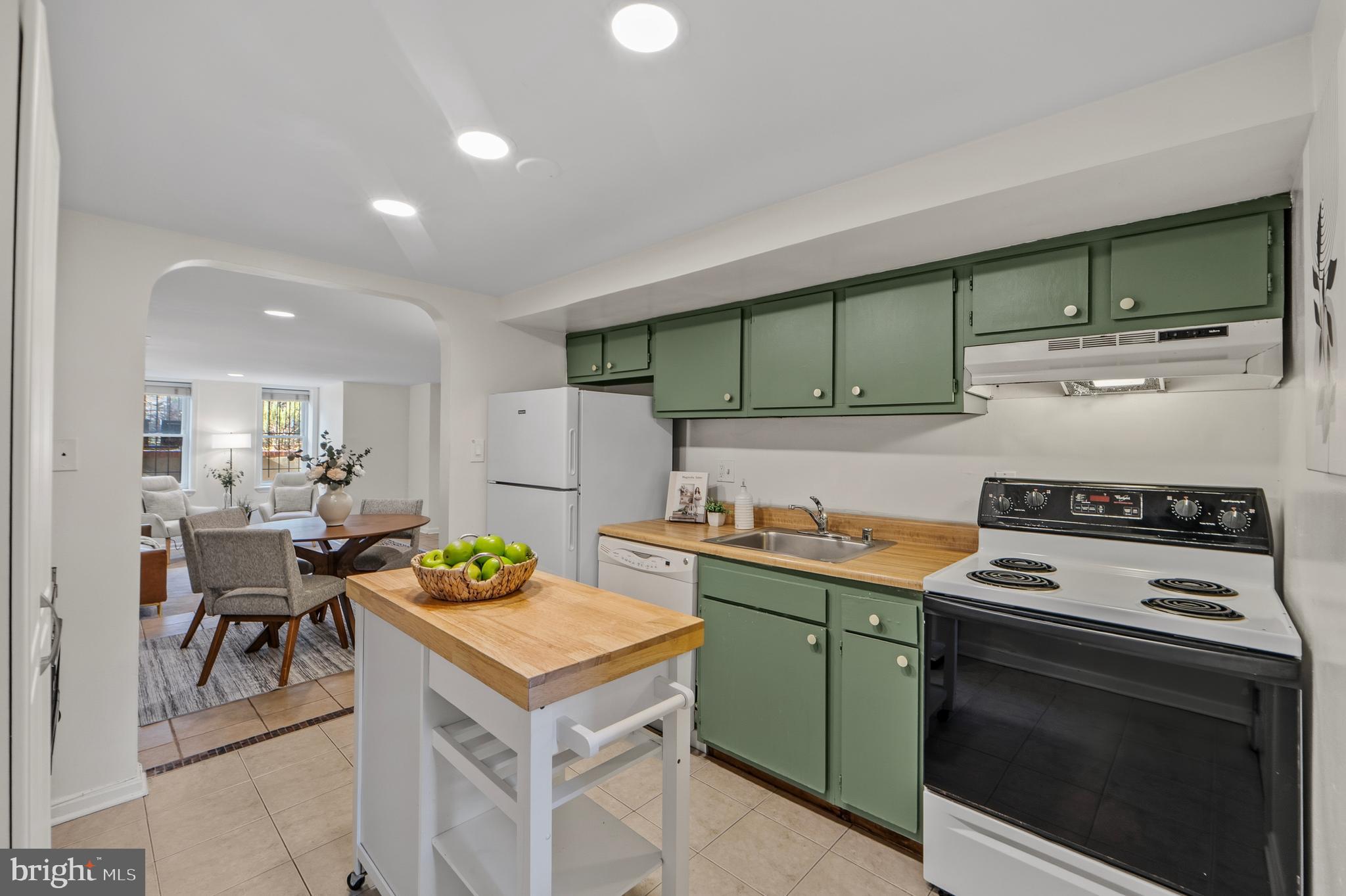 1927 15th Street Northwest Washington, DC 20009 - Photo 42 of 59 a kitchen with a stove a sink cabinets and wooden floor