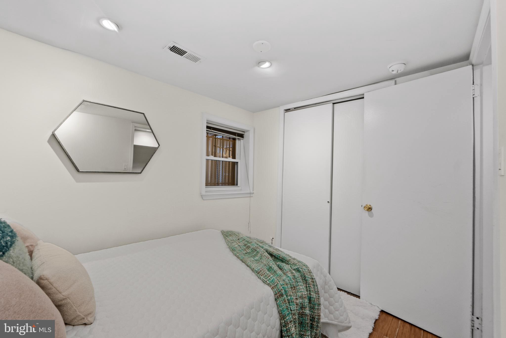 1927 15th Street Northwest Washington, DC 20009 - Photo 49 of 59 a bedroom with a bed and a mirror