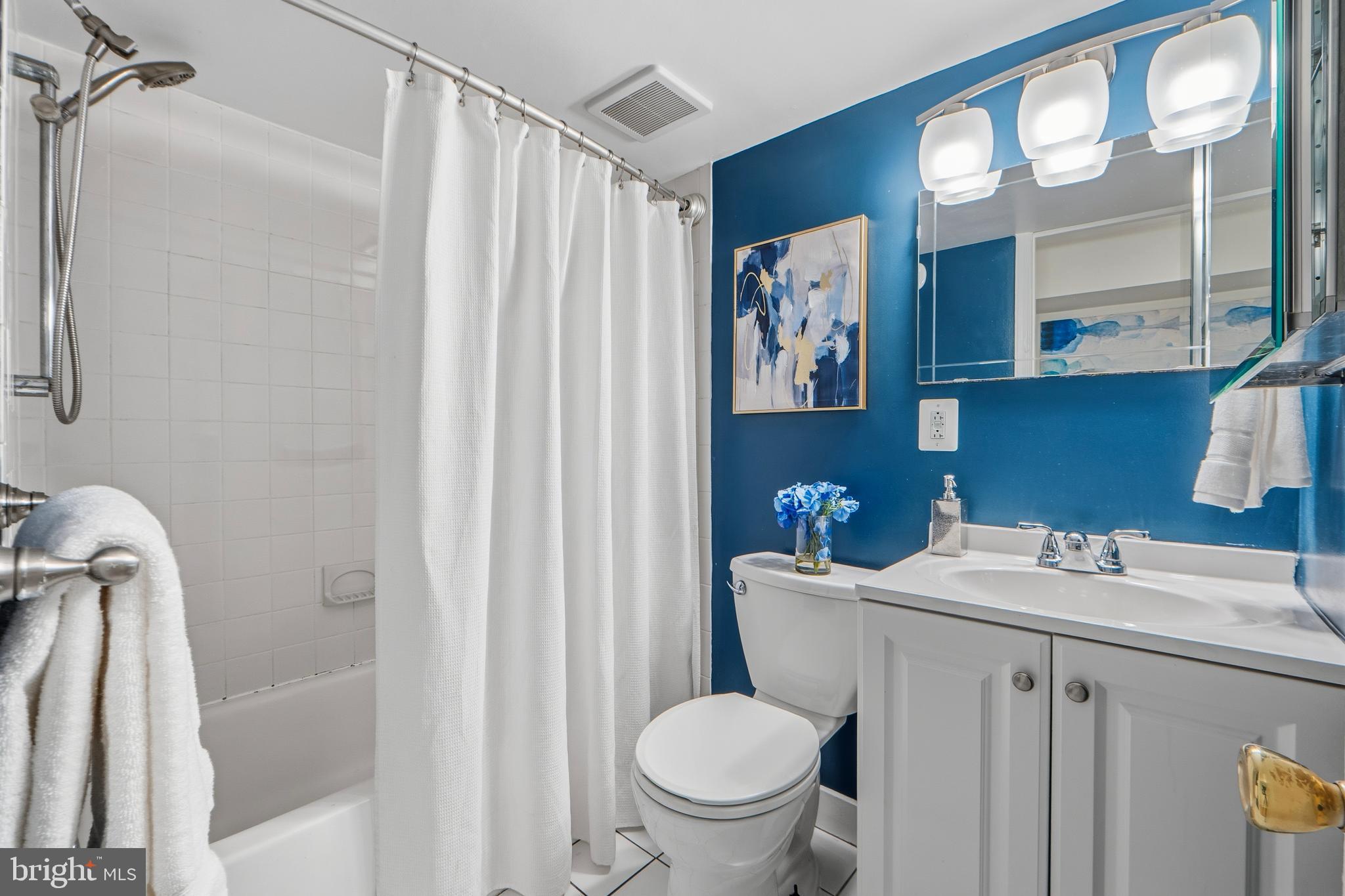 1927 15th Street Northwest Washington, DC 20009 - Photo 50 of 59 a bathroom with a sink a toilet and shower curtain