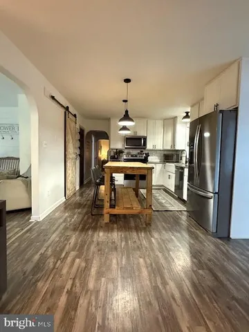 a kitchen with stainless steel appliances a refrigerator and a stove top oven