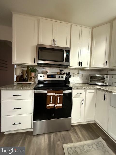 37181 Asher Road Mechanicsville, MD 20659 - Photo 15 of 50 a kitchen with granite countertop white cabinets and stainless steel appliances