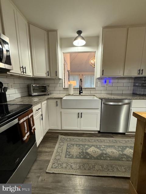 37181 Asher Road Mechanicsville, MD 20659 - Photo 16 of 50 a kitchen with stainless steel appliances granite countertop a sink stove and cabinets
