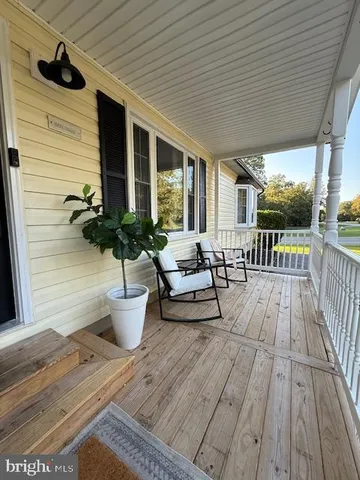 a view of a patio with couches and potted plants