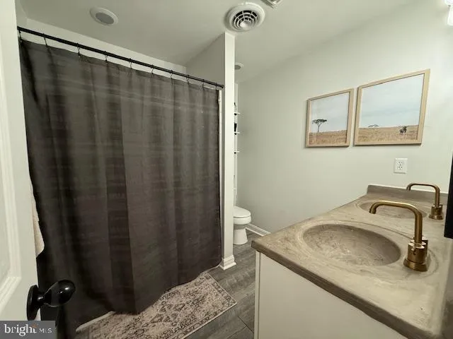 a living room with furniture a dining table and chairs with wooden floor