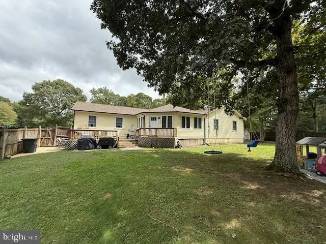 a front view of a house with a garden and trees