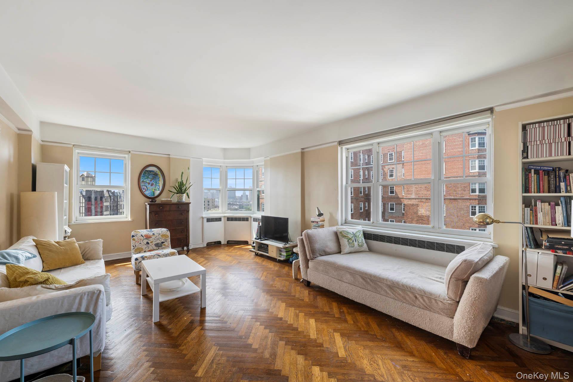 Living area featuring baseboards and radiator