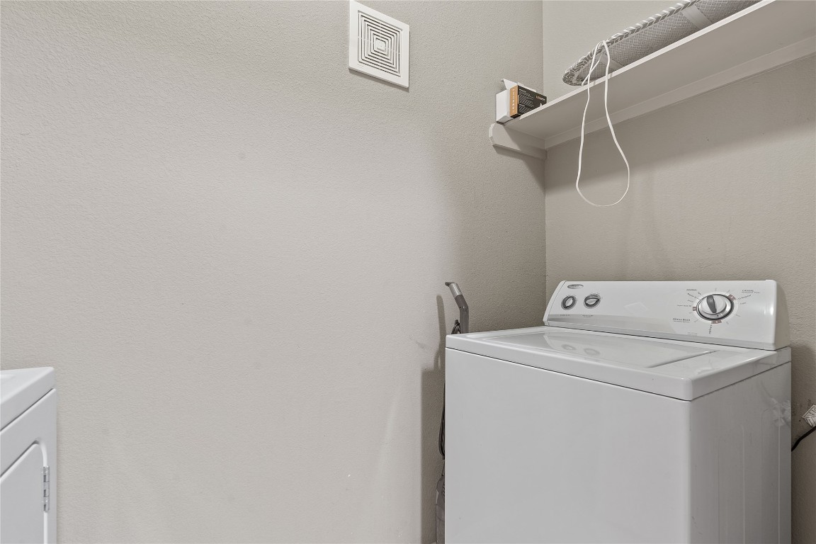 2515 Pearl Street, Unit 315 Austin, TX 78705 - Photo 17 of 17 Laundry area featuring a textured wall and separate washer and dryer