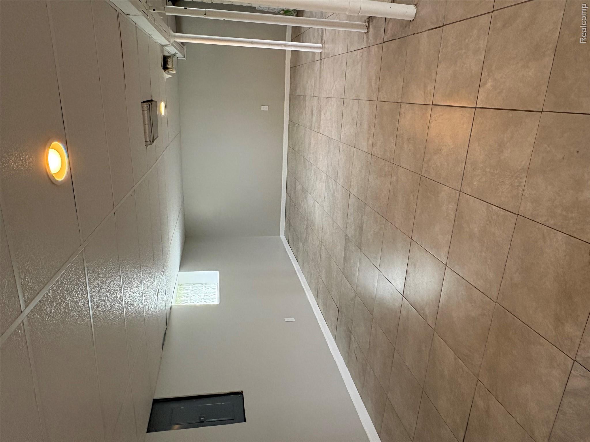 2175 West Auburn Road Rochester, MI 48309 - Photo 29 of 30 Basement with electric panel, light tile patterned floors, and a paneled ceiling