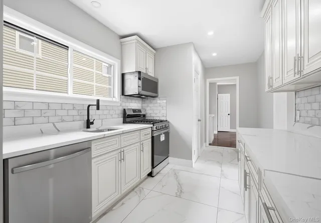 a kitchen with a sink stove and refrigerator