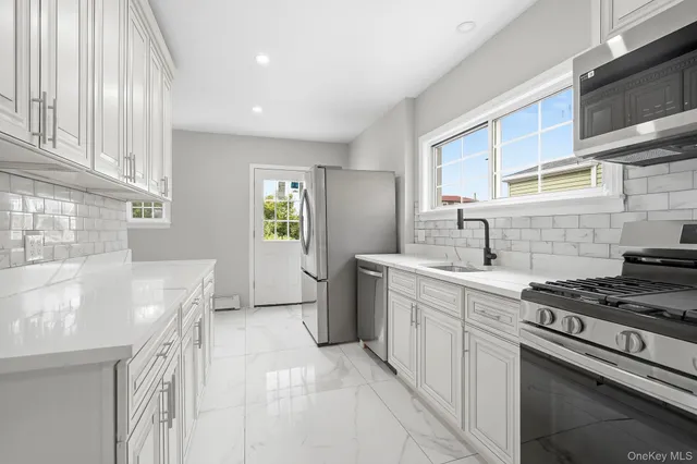 a kitchen that has a sink and a stove