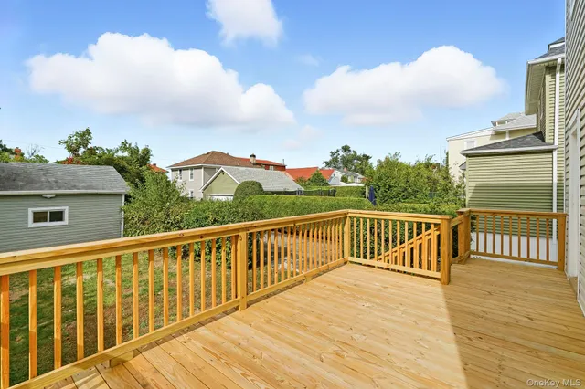 a view of a balcony with wooden floor