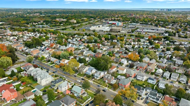 an aerial view of residential houses with outdoor space and trees