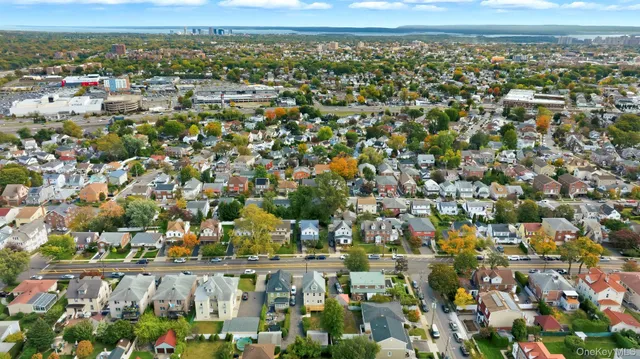 an aerial view of residential houses with outdoor space and trees