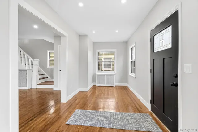 a view of a hallway view with wooden floor and staircase
