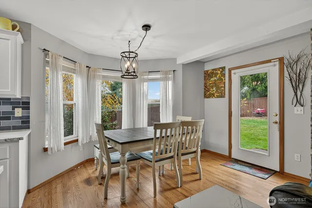 a view of a dining room with furniture window and wooden floor